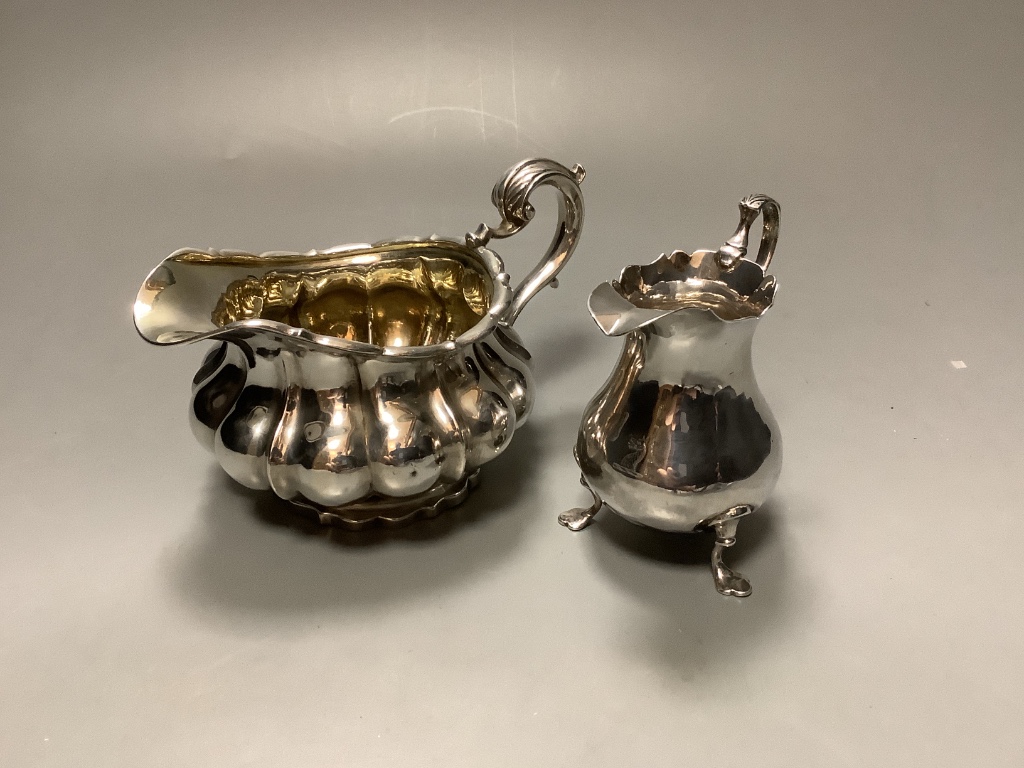 A George III silver baluster cream jug and a George IV silver cream jug 10.9oz